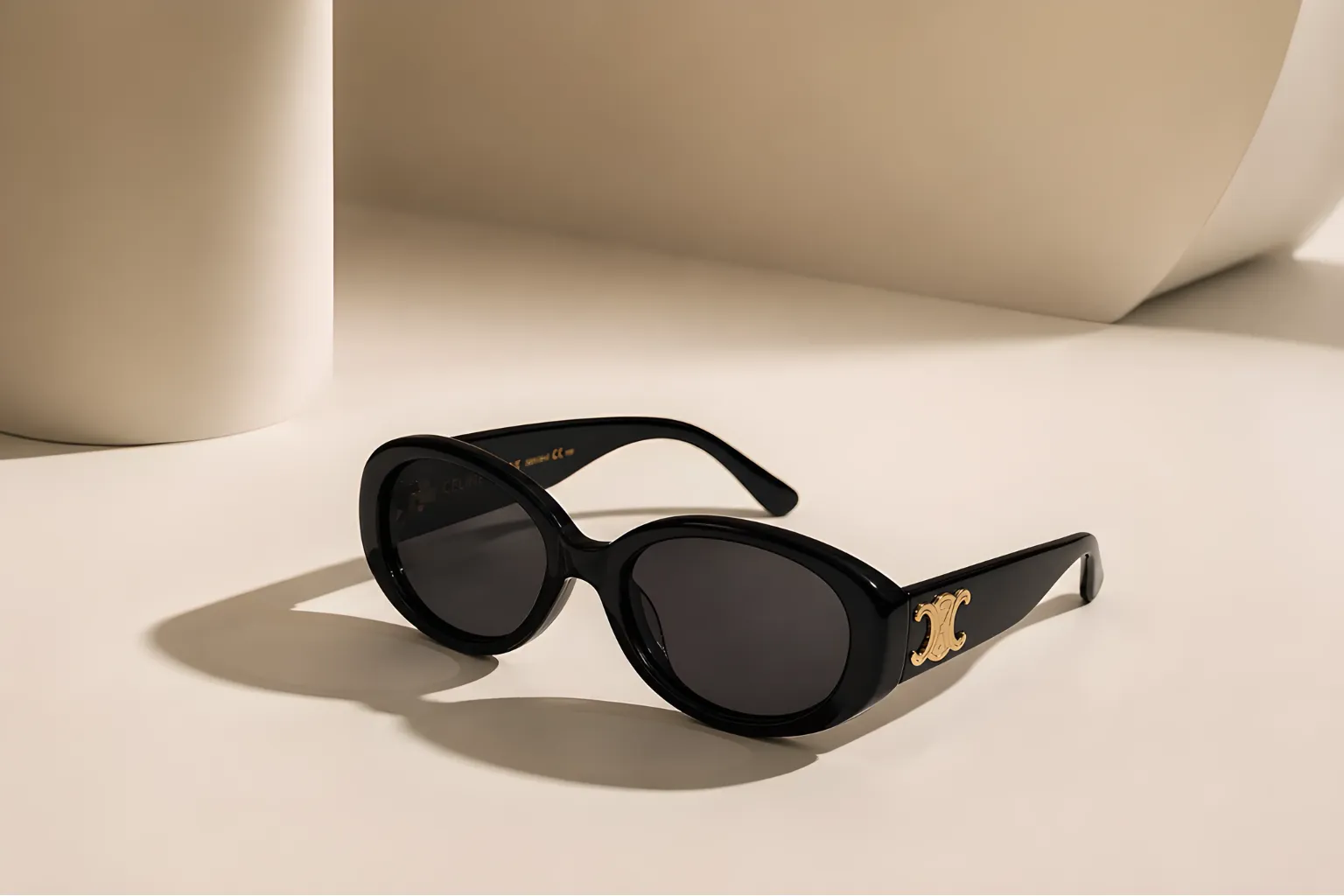 Luxury black sunglasses in minimal studio setting with elegant soft lighting